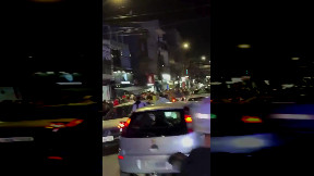 Biker weaves through highway traffic