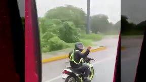 Guy on motorcycle gives the middle finger