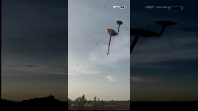 Man gets lifted into air by a kite