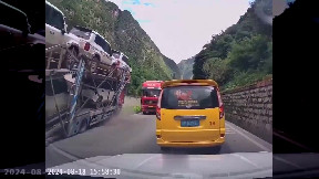 Loaded truck almost crushes car
