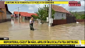 Romanian journalist falls into hole while filming report on flood-stricken region