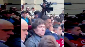 Reporter accidentally pushes microphone into President of Argentina Miley's face