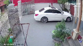 Woman closing the gate on a windy day