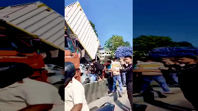 Indian guy walks away after car is crushed