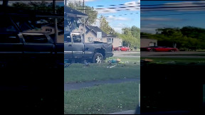 Man atop a house after he was apparently ejected from his truck