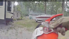 Body cam shows Roscommon Co. deputy run into burning garage, putting out fire