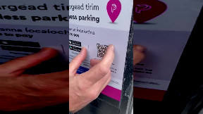 Fake QR code sticker on a car parking payment machine